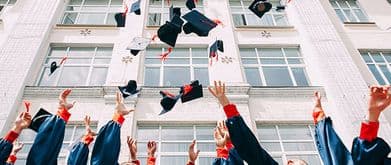 graduates throwing caps