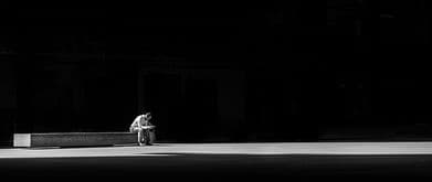 black and white photo of a man sitting and reading