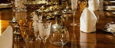 gilded goblets sit on a long table