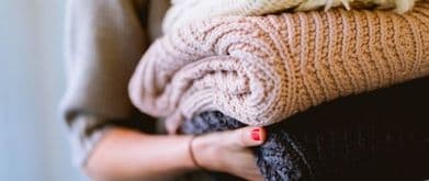 woman holding folded laundry