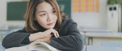 woman resting her hands on a feel good book