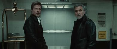 Brad Pitt and George Clooney stare at something shocking off-screen.